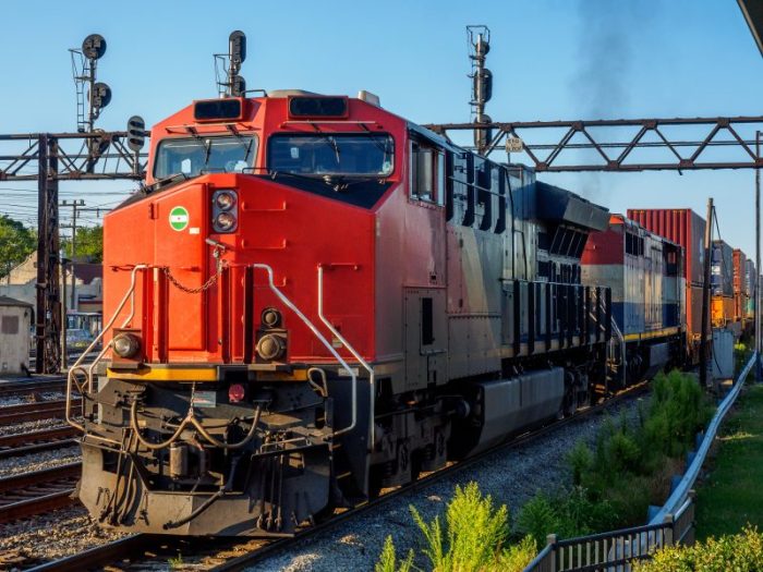 red locomotive on train tracks